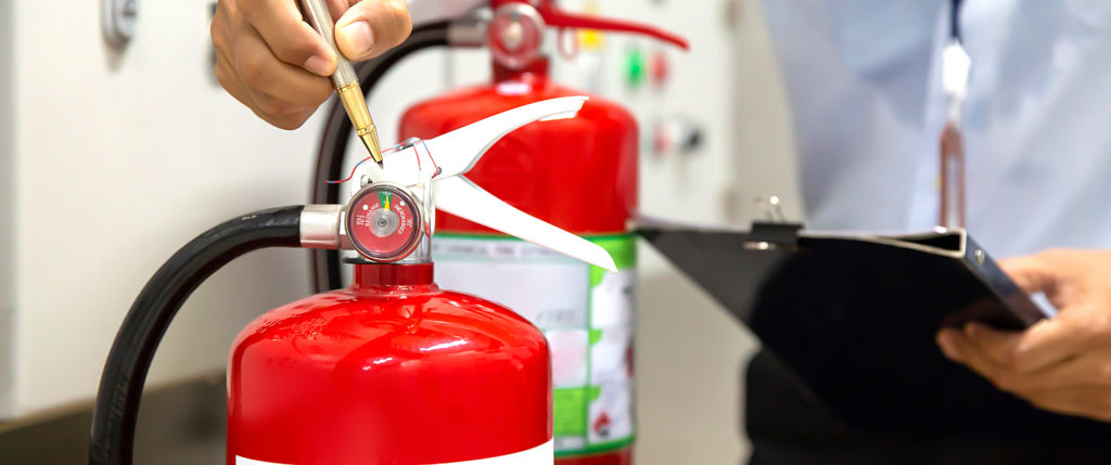 Man inspecting fire extinguisher